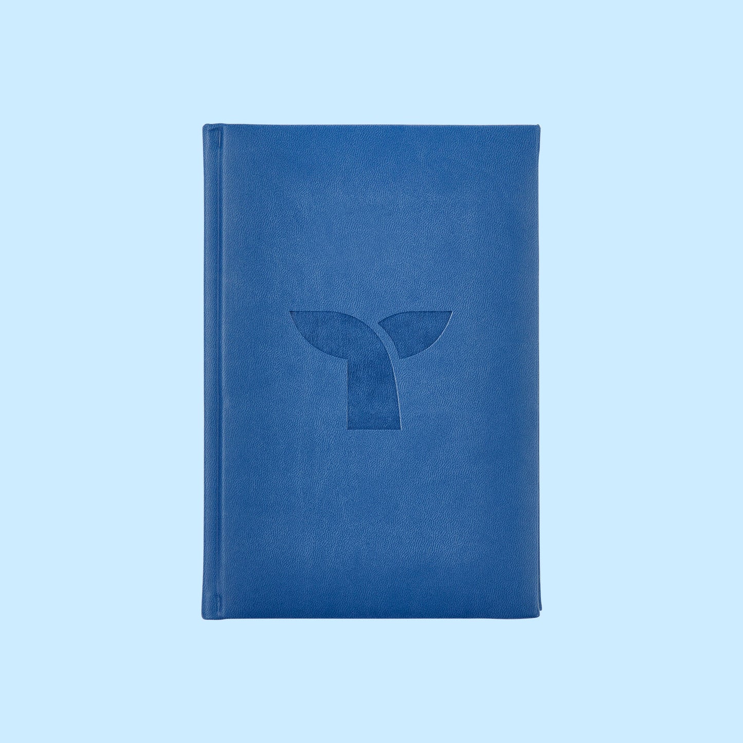 Triple Whale logomark debossed on front of blue journal